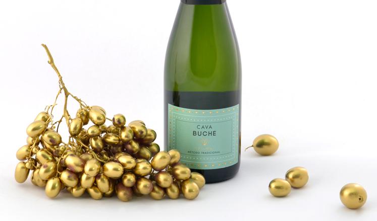 Golden grapes and a bottle of Cava Buche.