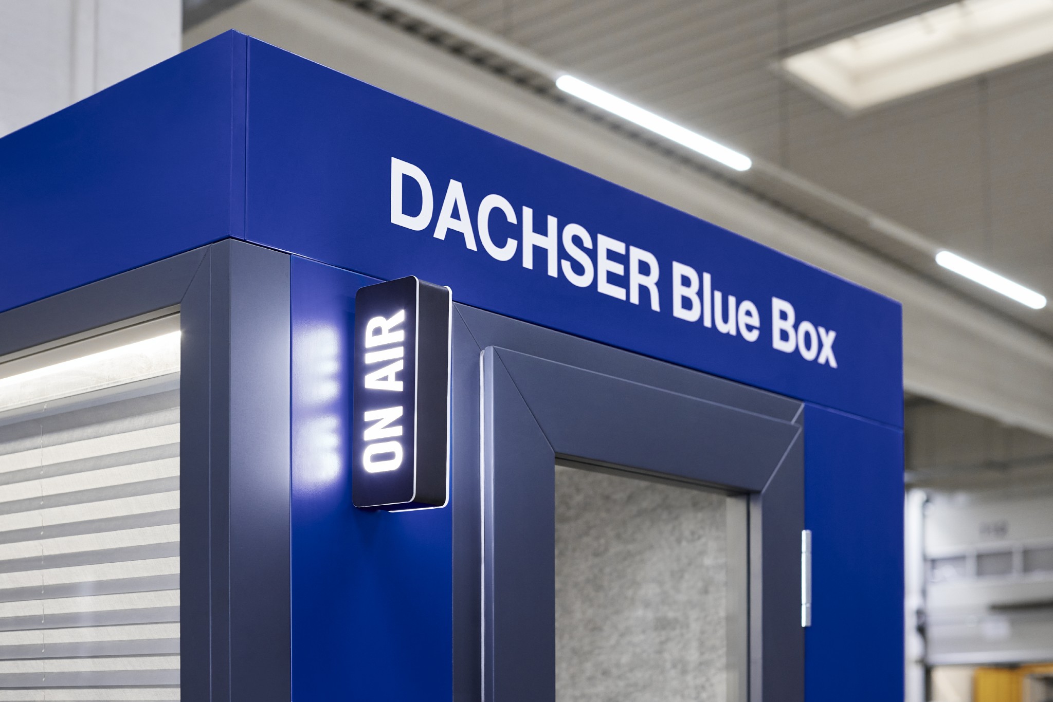 Close-up of a blue Dachser Blue Box with an illuminated On Air sign on the side, indicating active usage.