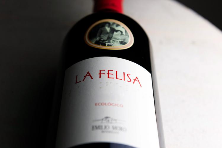 A bottle of La Felisa wine laying down.
