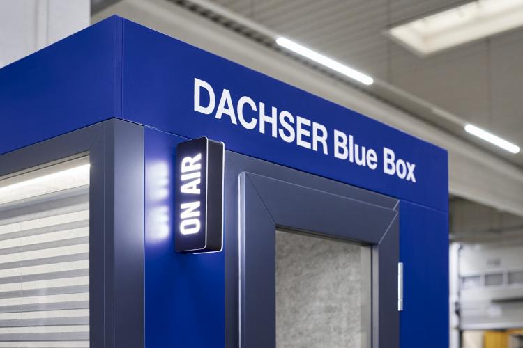 Close-up of a blue Dachser Blue Box with an illuminated On Air sign on the side, indicating active usage.
