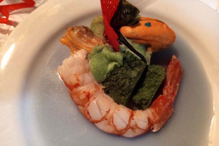 A plate of sea salad on red cabbage cream and plankton potatoes, seaweed and seafood by chef Roberto Capone.