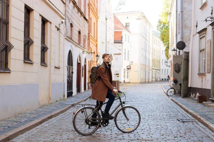 A young man exploring a city in a bike.