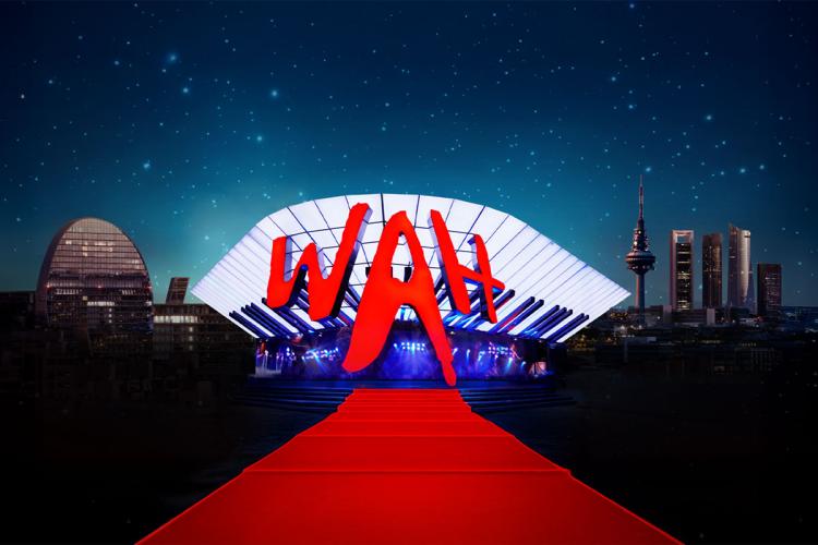 New WAH performance venue featuring a large illuminated structure, the red WAH logo, and a red carpet in the foreground, set against Madrid’s nighttime cityscape.