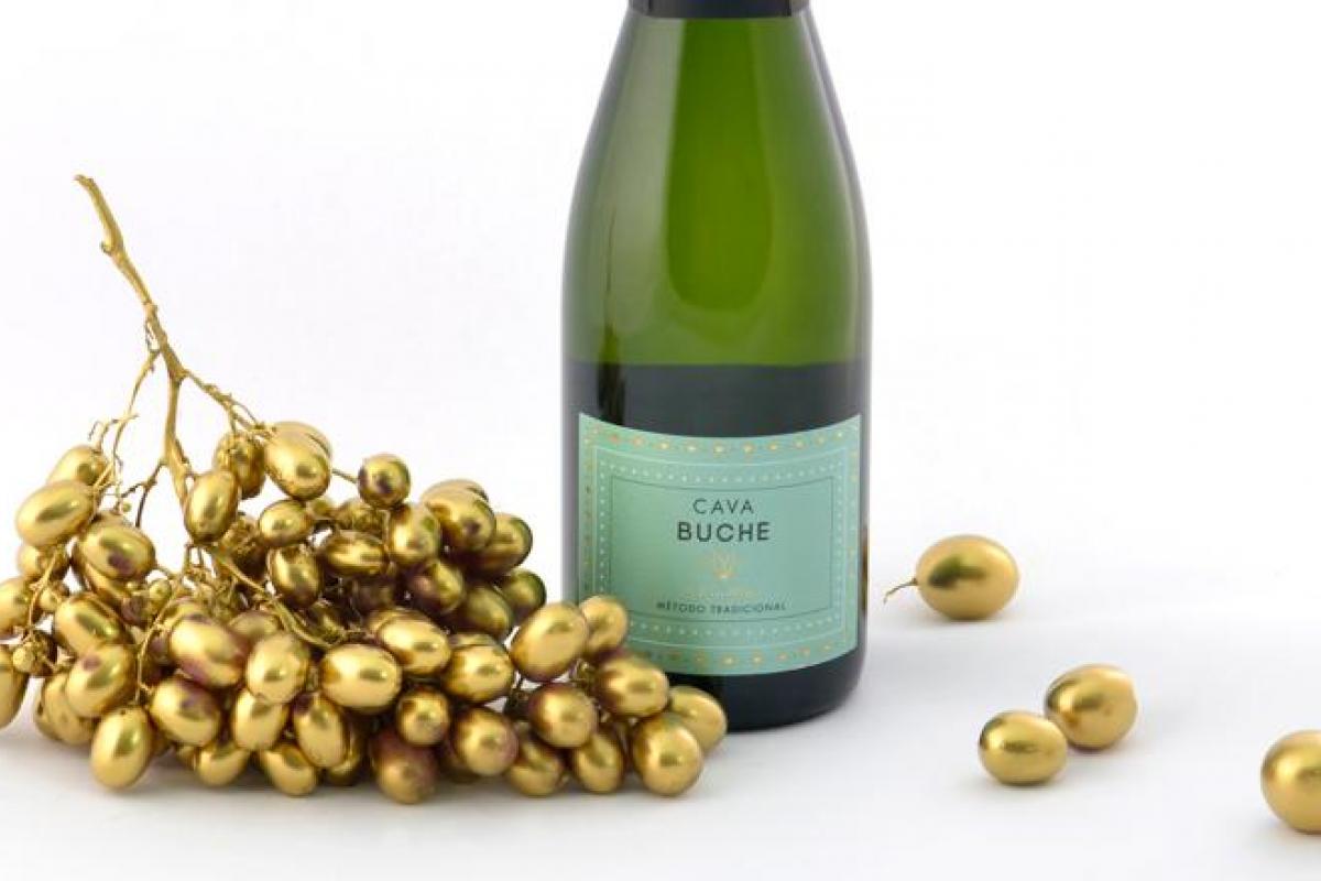 Golden grapes and a bottle of Cava Buche.